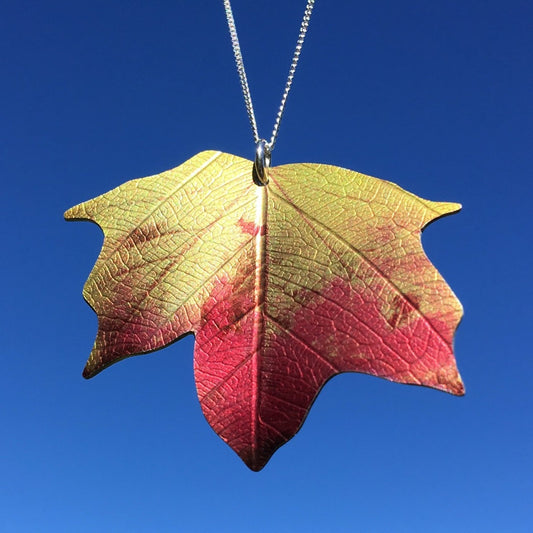 Colourful autumn Maple leaf necklace. Made using a photograph transposed onto recycled aluminium